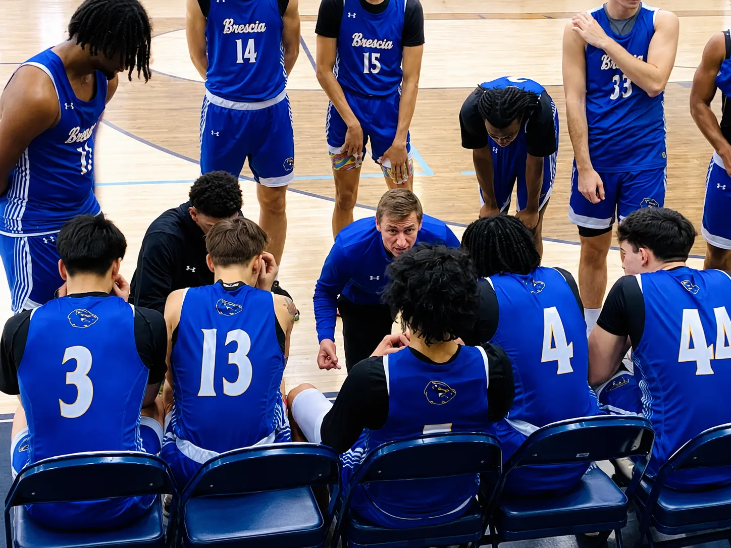 Coach Karn huddling with the Bearcats